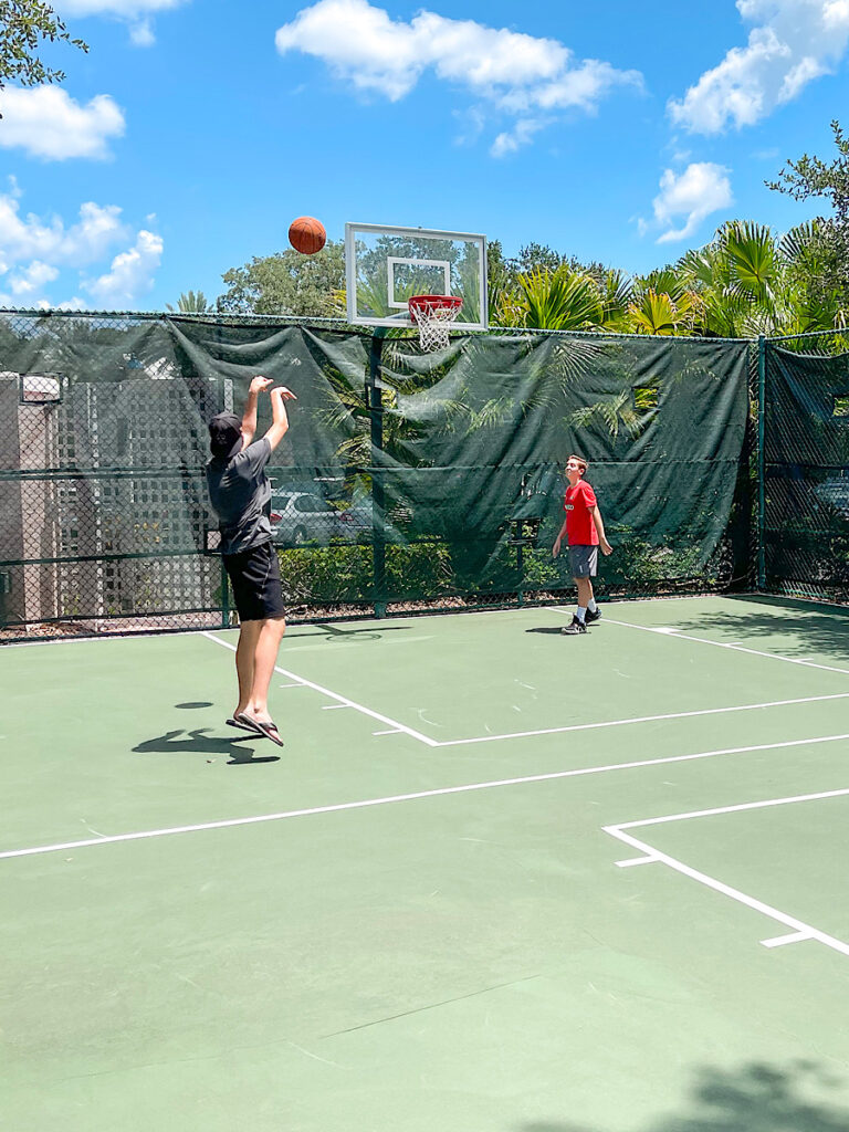 Two kids playing basketball at Disney's Old Key West Resort.