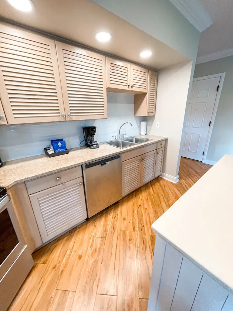 Cabinets, sink, and dishwasher in an Old Key West suite.