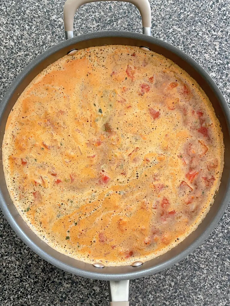 Tomato soup boiling in a pan.