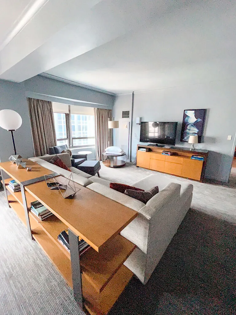 Sitting area with couch and tv in the Presidential Suite at Hilton New York Midtown.