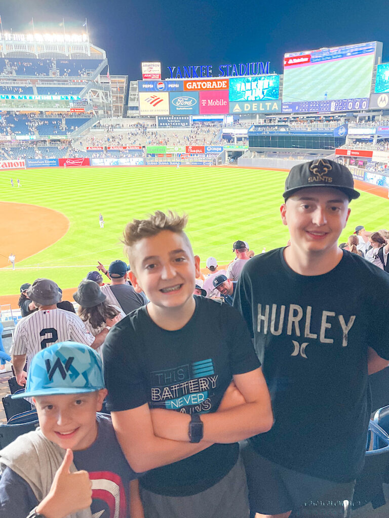 Three kids at Yankee Stadium.
