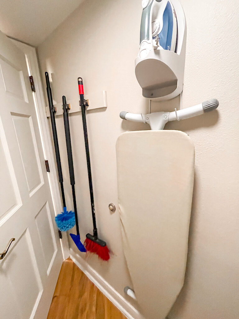 Ironing Board and brooms in a 1-bedroom suite at Old Key West.
