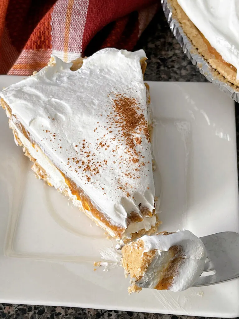 A slice of no bake pumpkin pie with no bake cheesecake.
