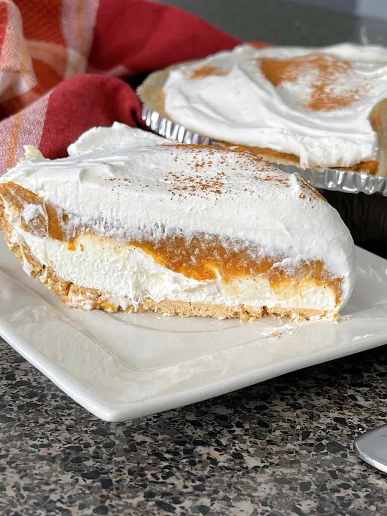 A slice of no bake pumpkin pie with no bake cheesecake.