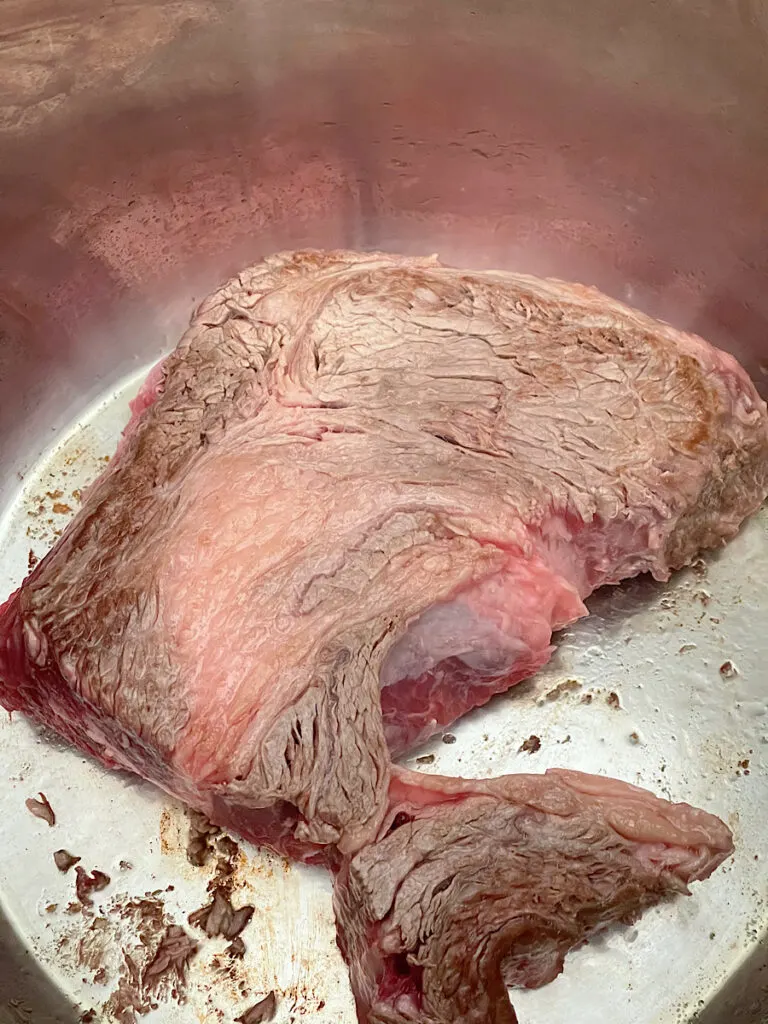A chuck roast in a slow cooker.