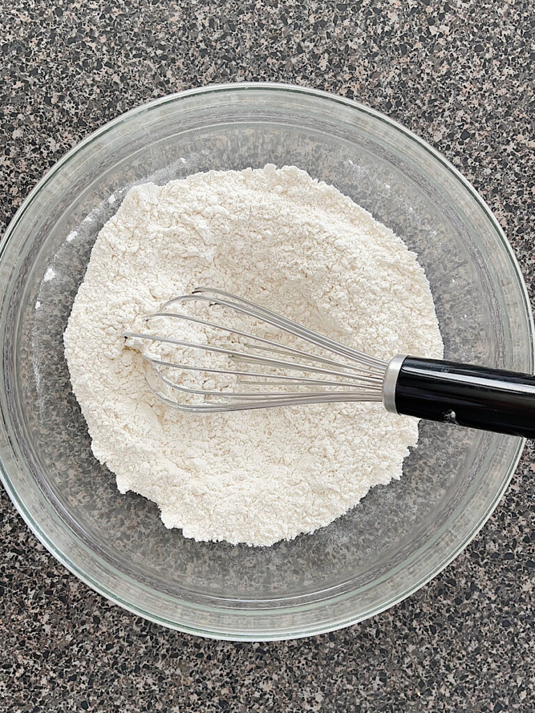 A bowl of flour, baking soda, and salt.