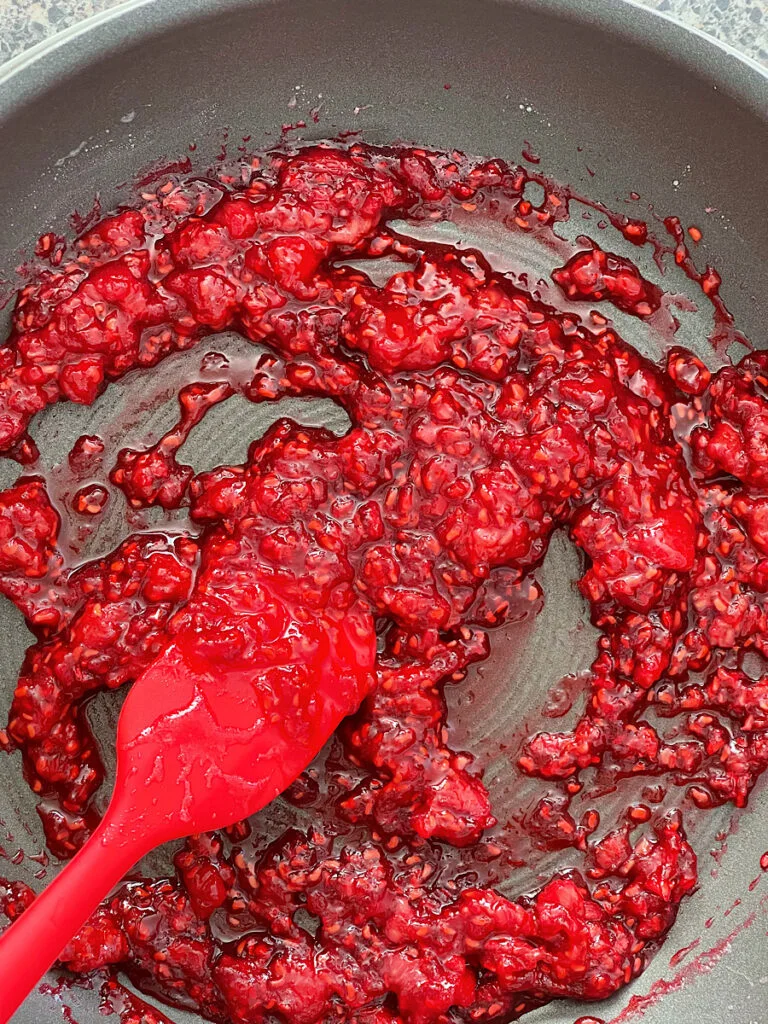 Raspberries, sugar, and lemon juice in a sauce pan.