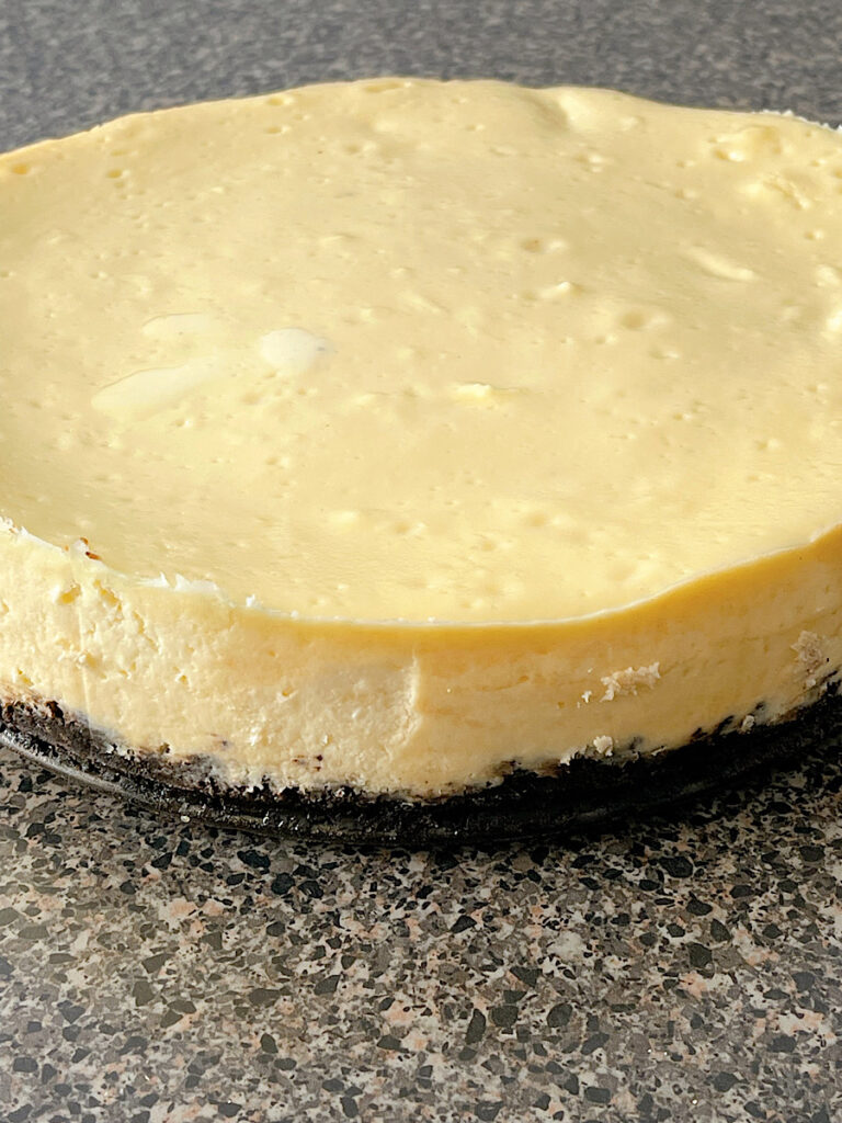 A white chocolate cheesecake with a cookie crust.