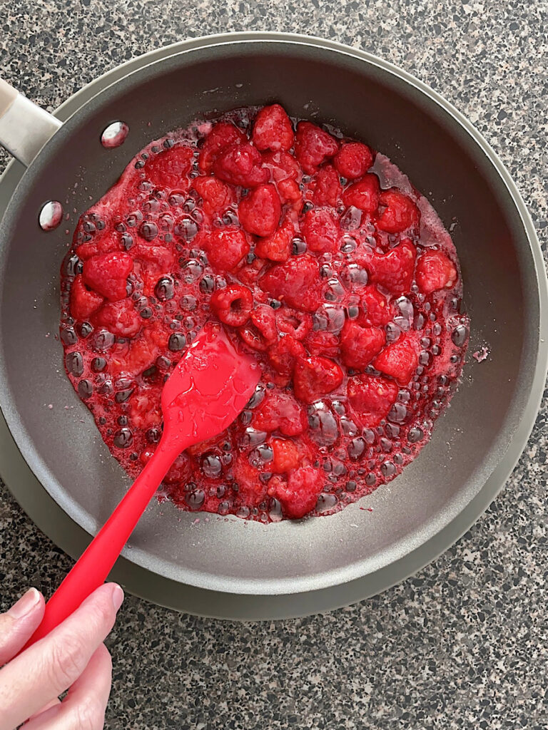 Raspberries, sugar, and lemon juice in a sauce pan.