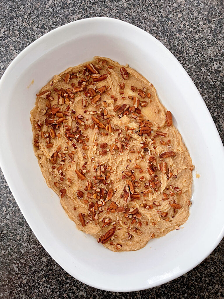Brown sugar and pecans on the bottom of a baking dish.