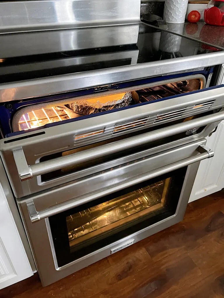 An oven range with the door propped open.