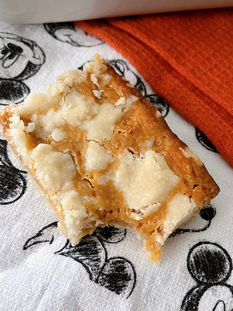 An Epcot Caramel Shortbread Bar on a Mickey Mouse towel.