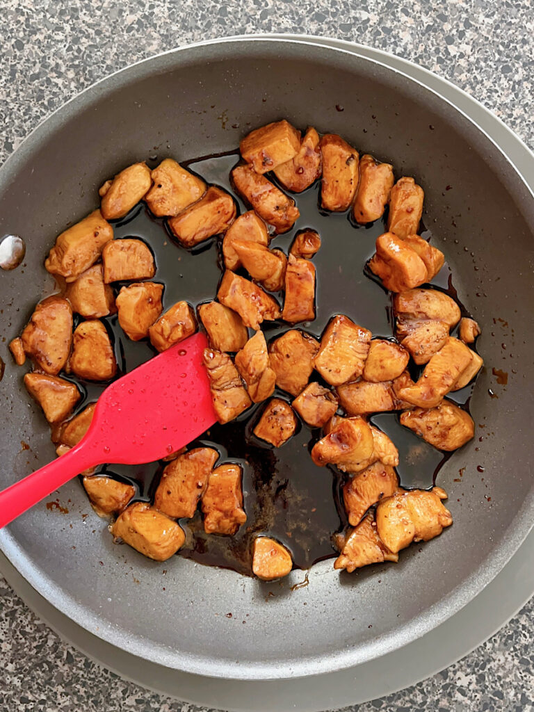 Chicken and teriyaki sauce in a pan.