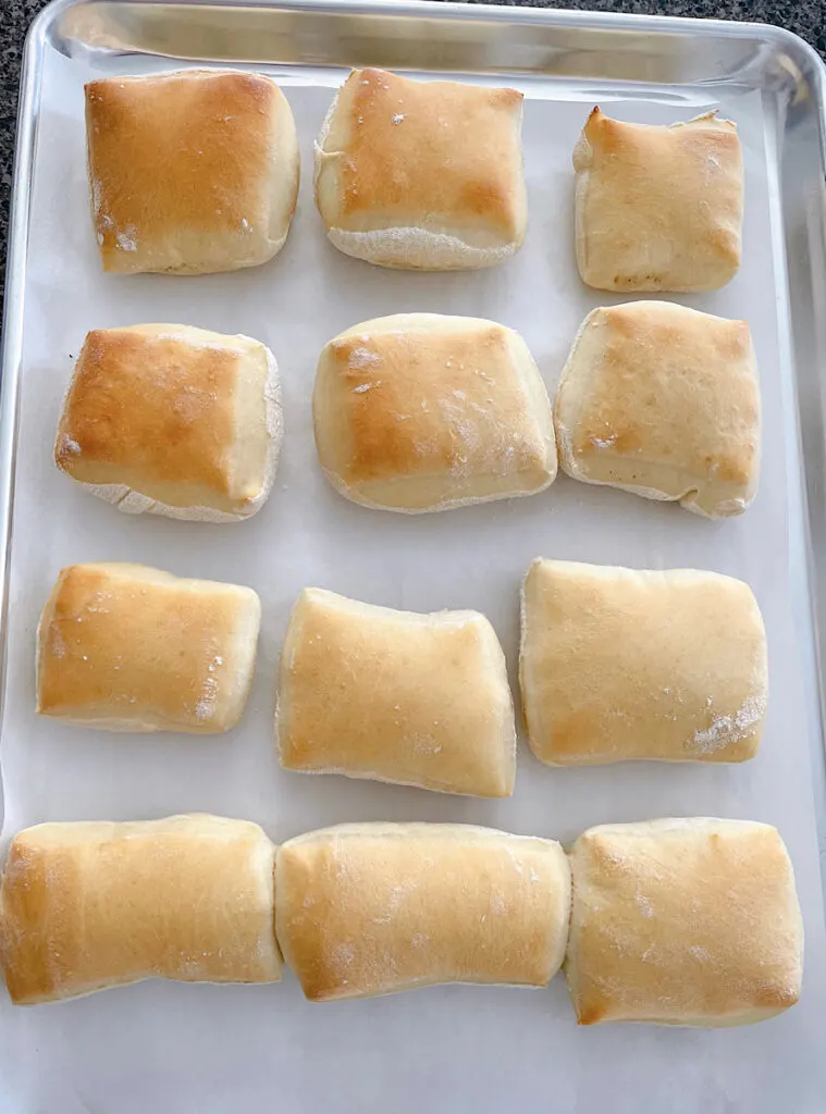 Freshly baked rolls on a baking sheet.