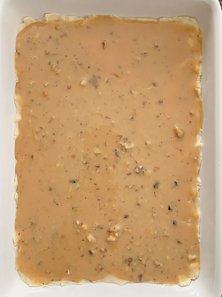 Caramel layer over shortbread to make caramel shortbread squares.