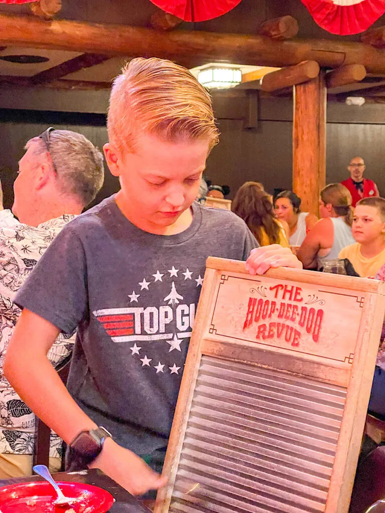 A boy playing the washboard during the Hoop-Dee-Doo Revue show.