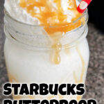 A Butterbeer Starbucks Frappuccino in a mason jar with a red and white straw.