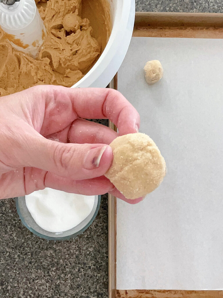 A peanut butter cookie dough ball rolled in white sugar.