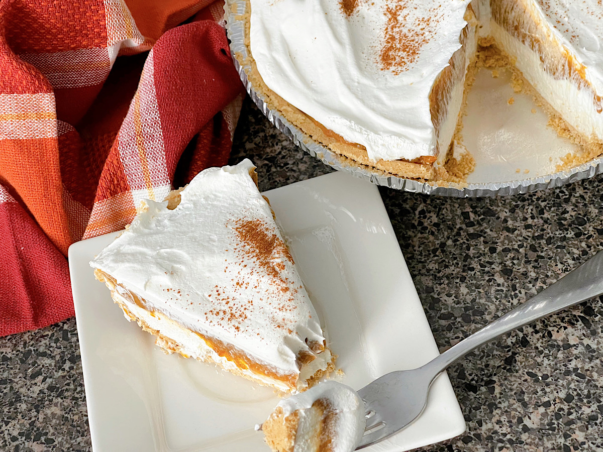 A slice of no bake pumpkin pie with no bake cheesecake.