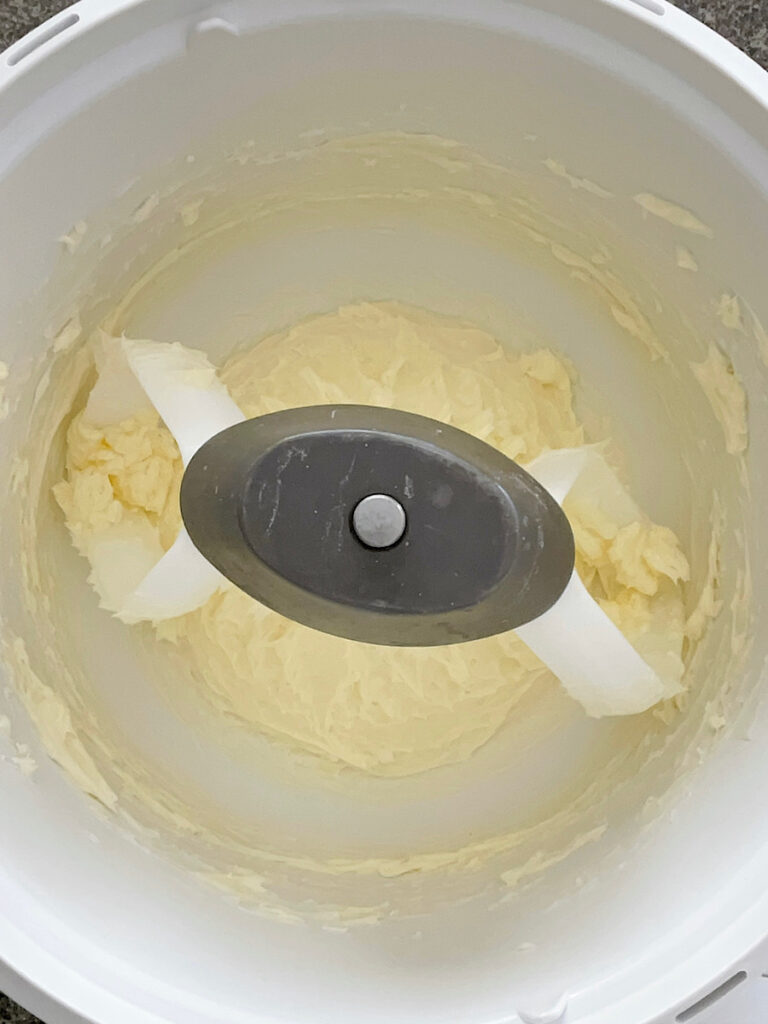 Butter in the bowl of a stand mixer.