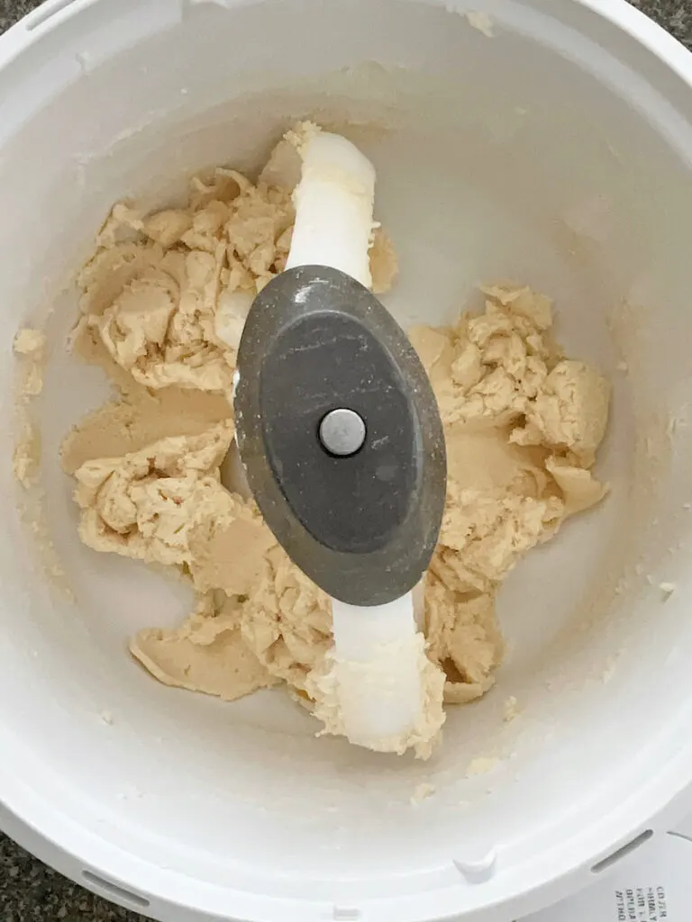 Shortbread dough in the bowl of a stand mixer.