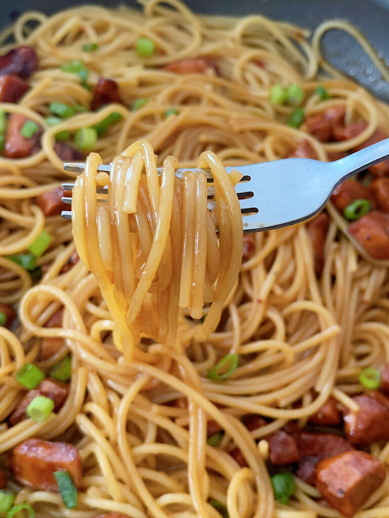 Spicy Thai noodles wrapped around a fork.