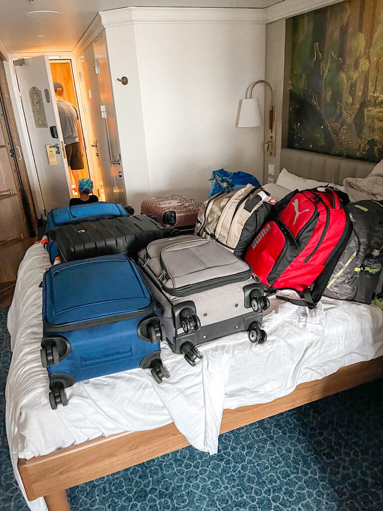 Luggage on a bed in Disney Cruise stateroom.