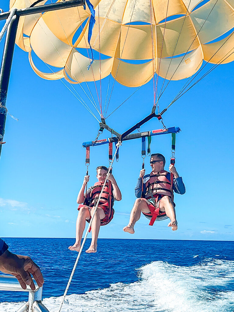 Two people parasailing at Castaway Cay.