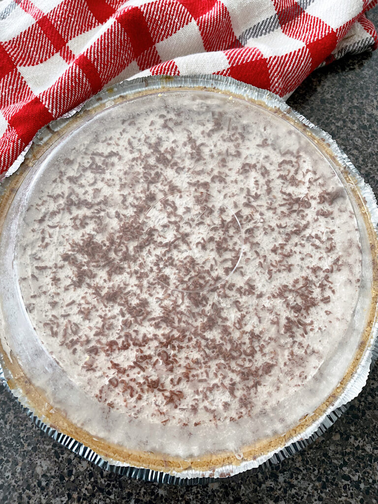 A chocolate Cool Whip Pie with a plastic lid.