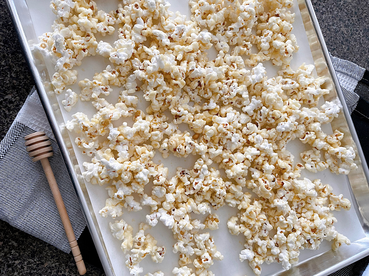 Salted honey popcorn on a baking sheet.