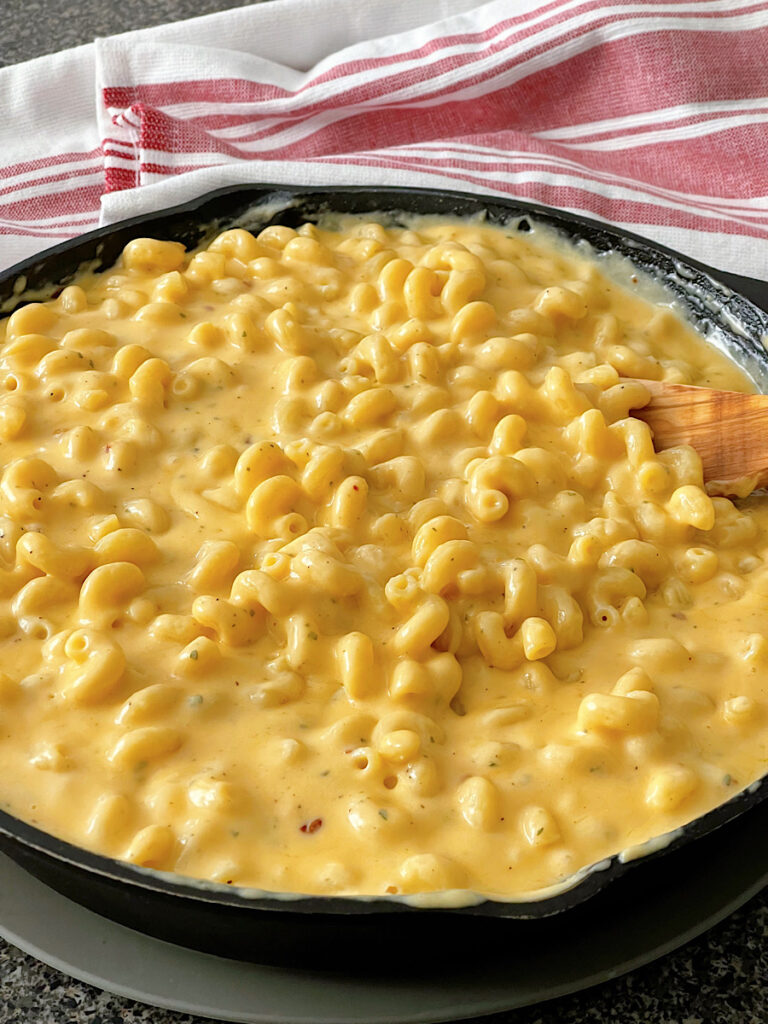 Homemade macaroni and cheese in a cast iron skillet.