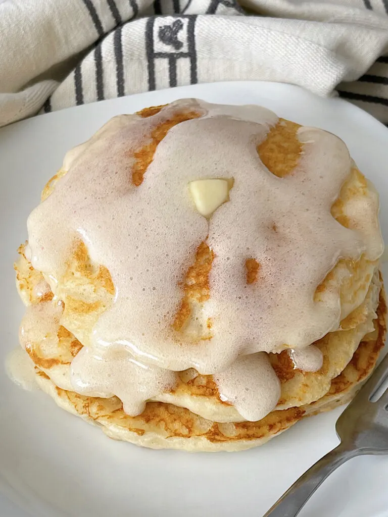 A stack of buttermilk pancakes made with Bisquick topped with butter and buttermilk syrup.