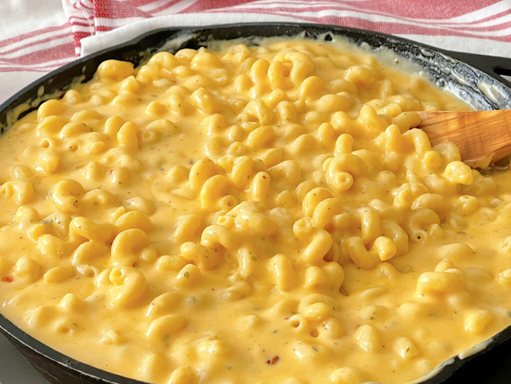 Homemade macaroni and cheese in a cast iron skillet.