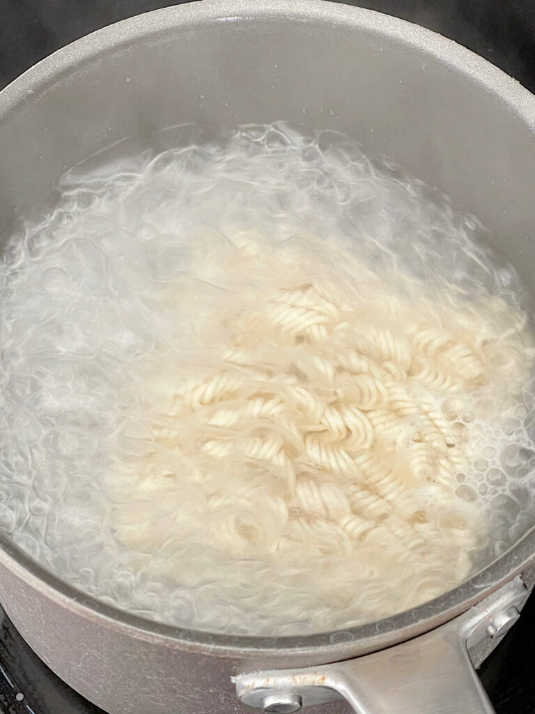 Ramen noodles in boiling water.