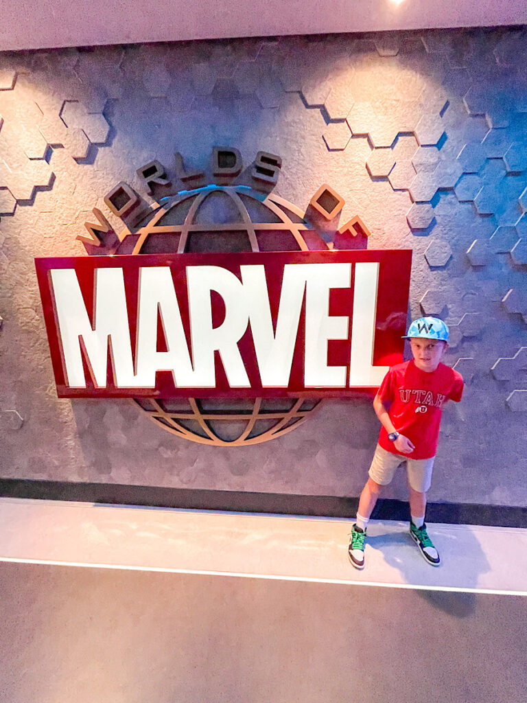 A child at the entrance to Worlds of Marvel on the Disney Wish.