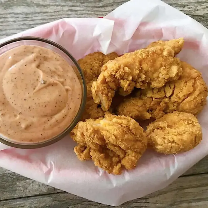 Raising Cane's Sauce with fried chicken fingers.