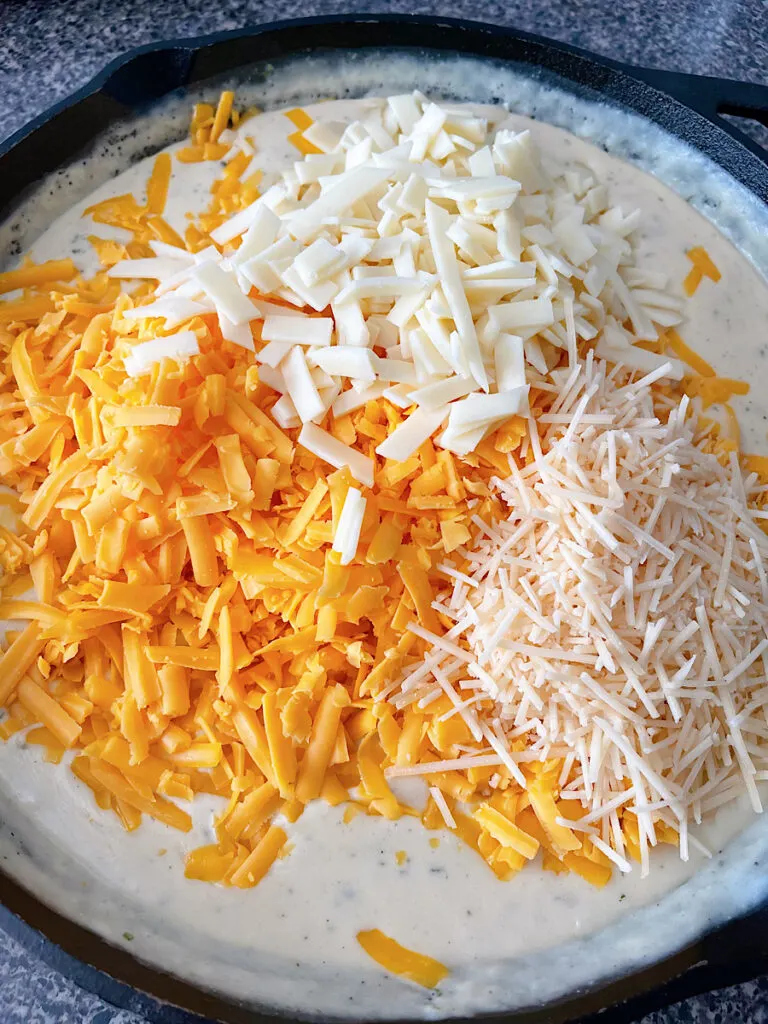 Three cheeses added to a sauce for skillet macaroni and cheese.