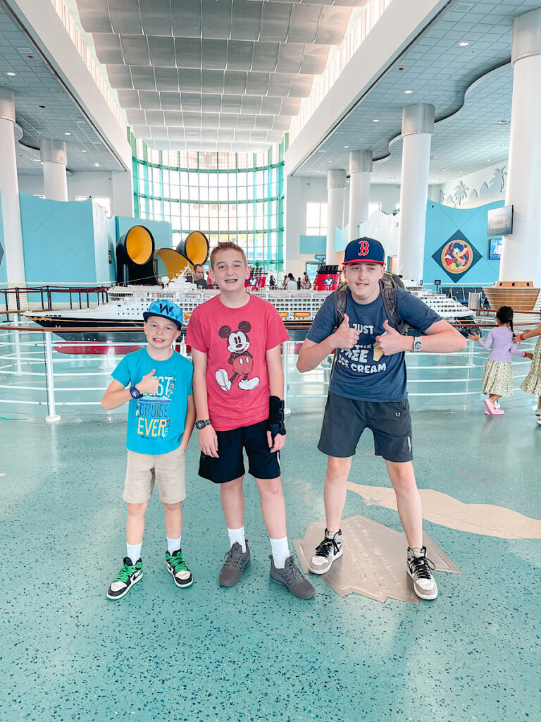Three kids in the Disney Cruise Line terminal in Port Canaveral.