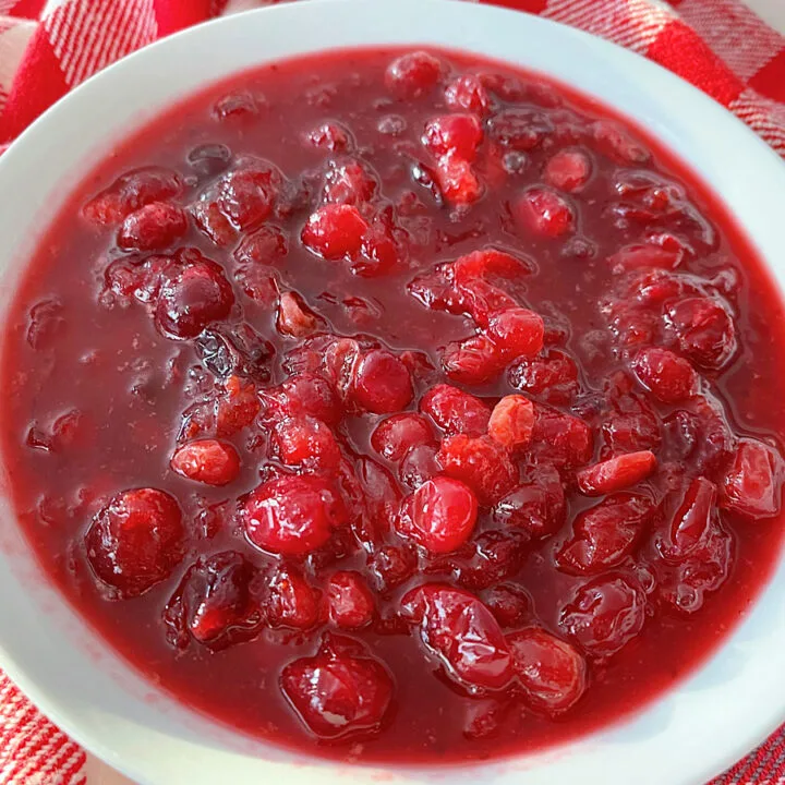A bowl of cranberry sauce with orange juice.