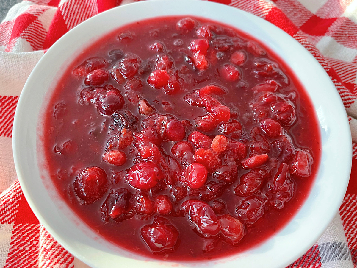 A bowl of cranberry sauce with orange juice.