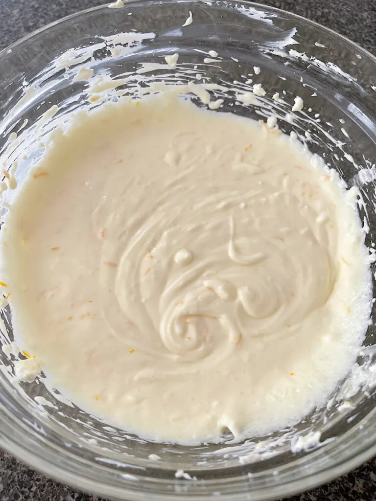 Orange cream cheese filling in a mixing bowl.