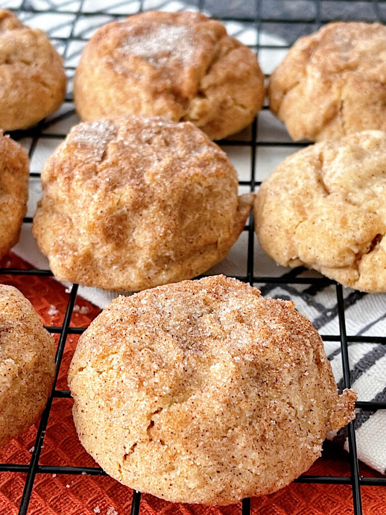 Pumpkin snickerdoodles on a cooling rack.