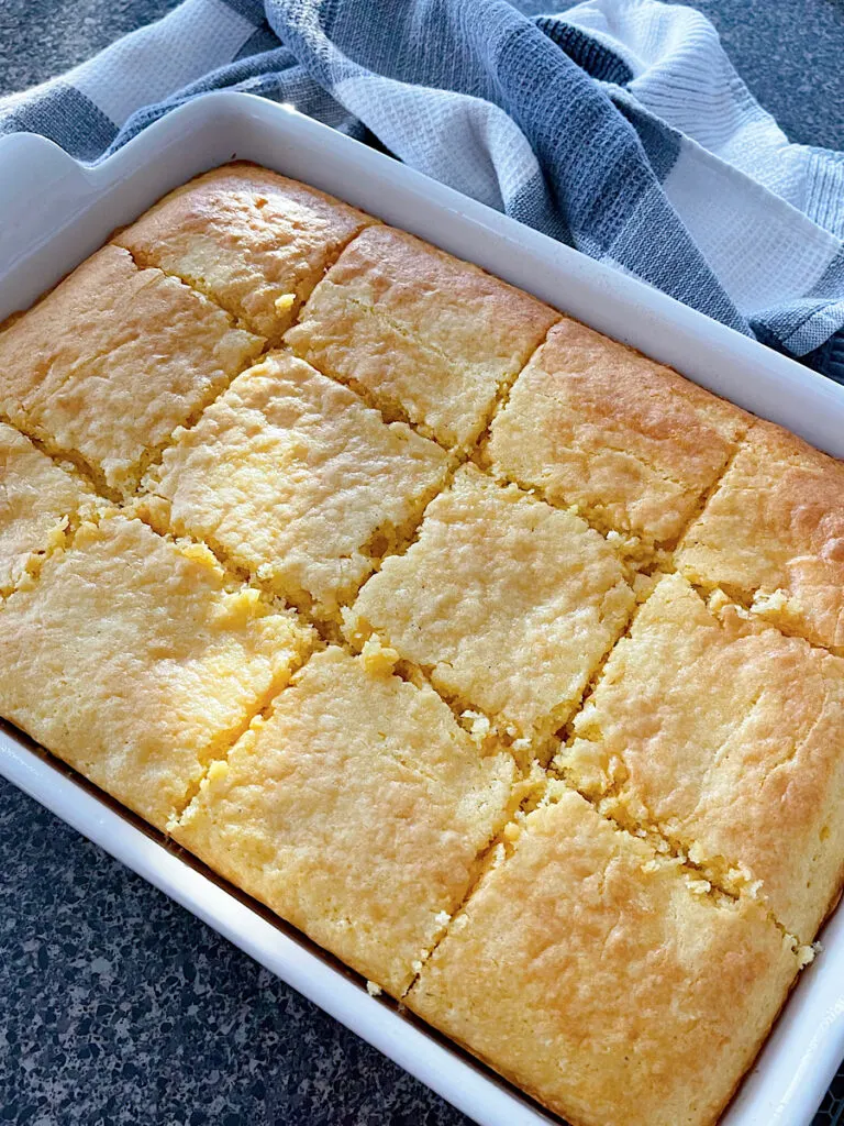 A pan of cornbread cake cut into slices.