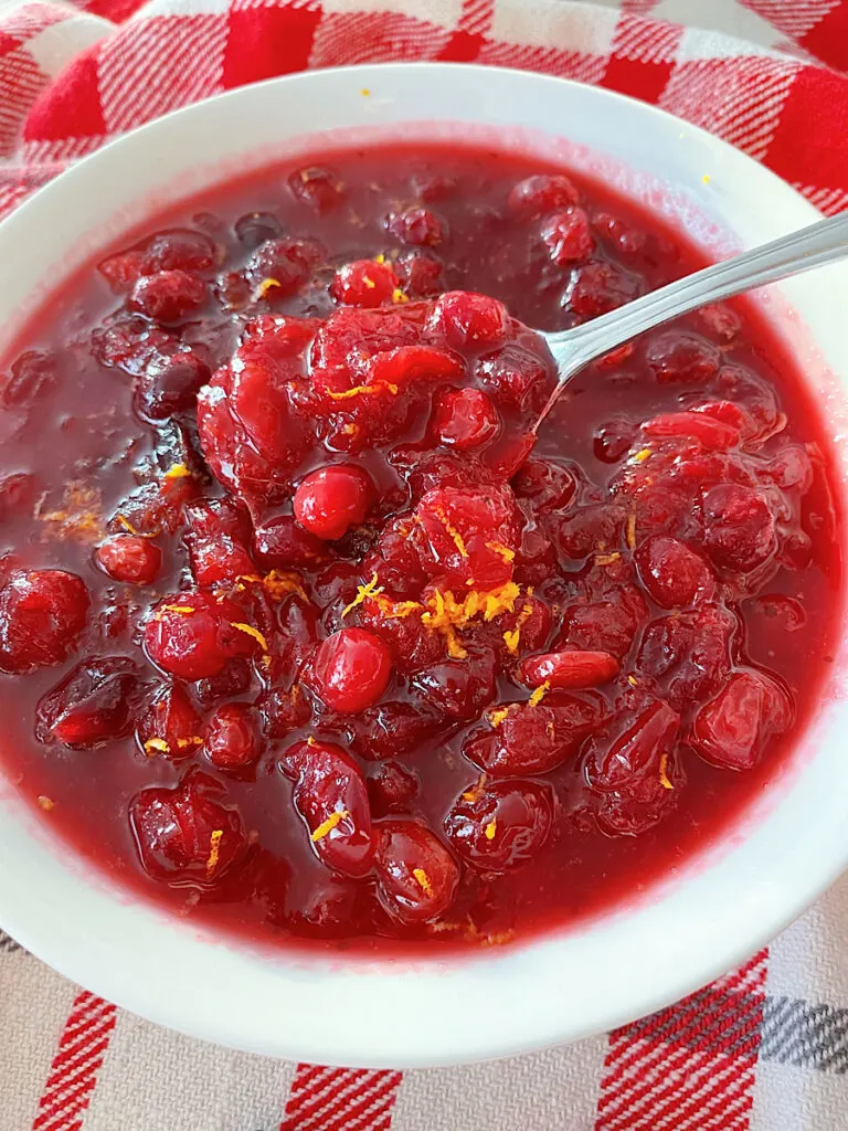 A bowl of cranberry sauce with orange juice.