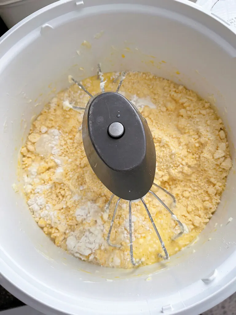 Cake mix cake ingredients in the bowl of a stand mixer.