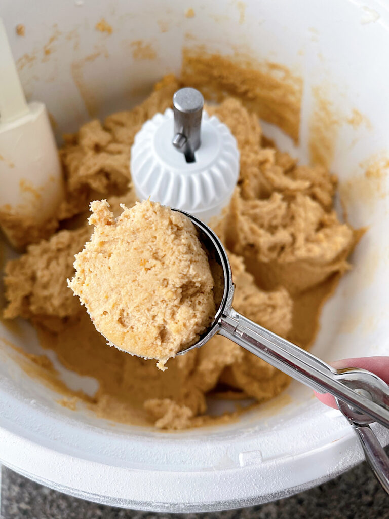 Pumpkin snickerdoodle dough in a cookie scoop.
