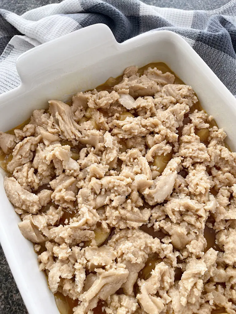 An unbaked apple crisp in a baking dish.