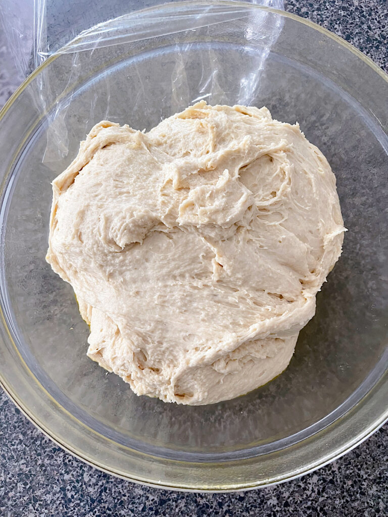 Orange roll dough in a mixing bowl.