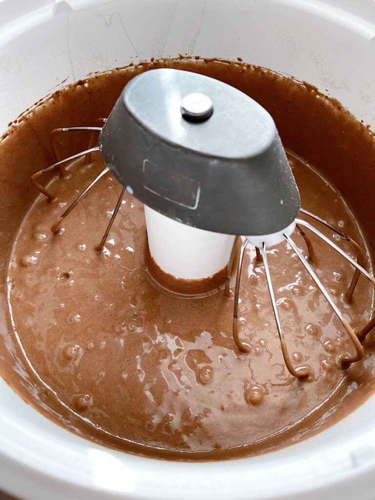 Chocolate cake batter in a stand mixer.