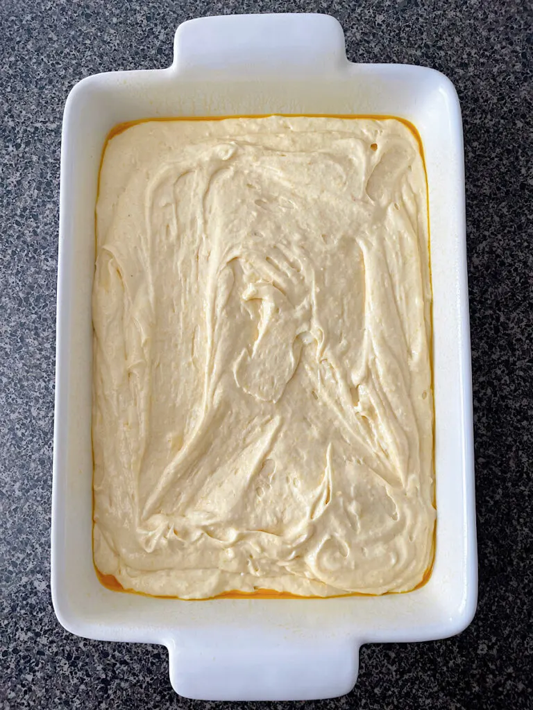 Cornbread cake batter in a cake pan.